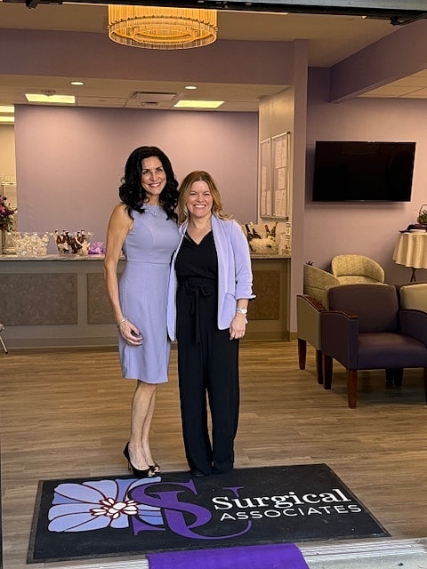 Two women posing outside Surgical Associates office.